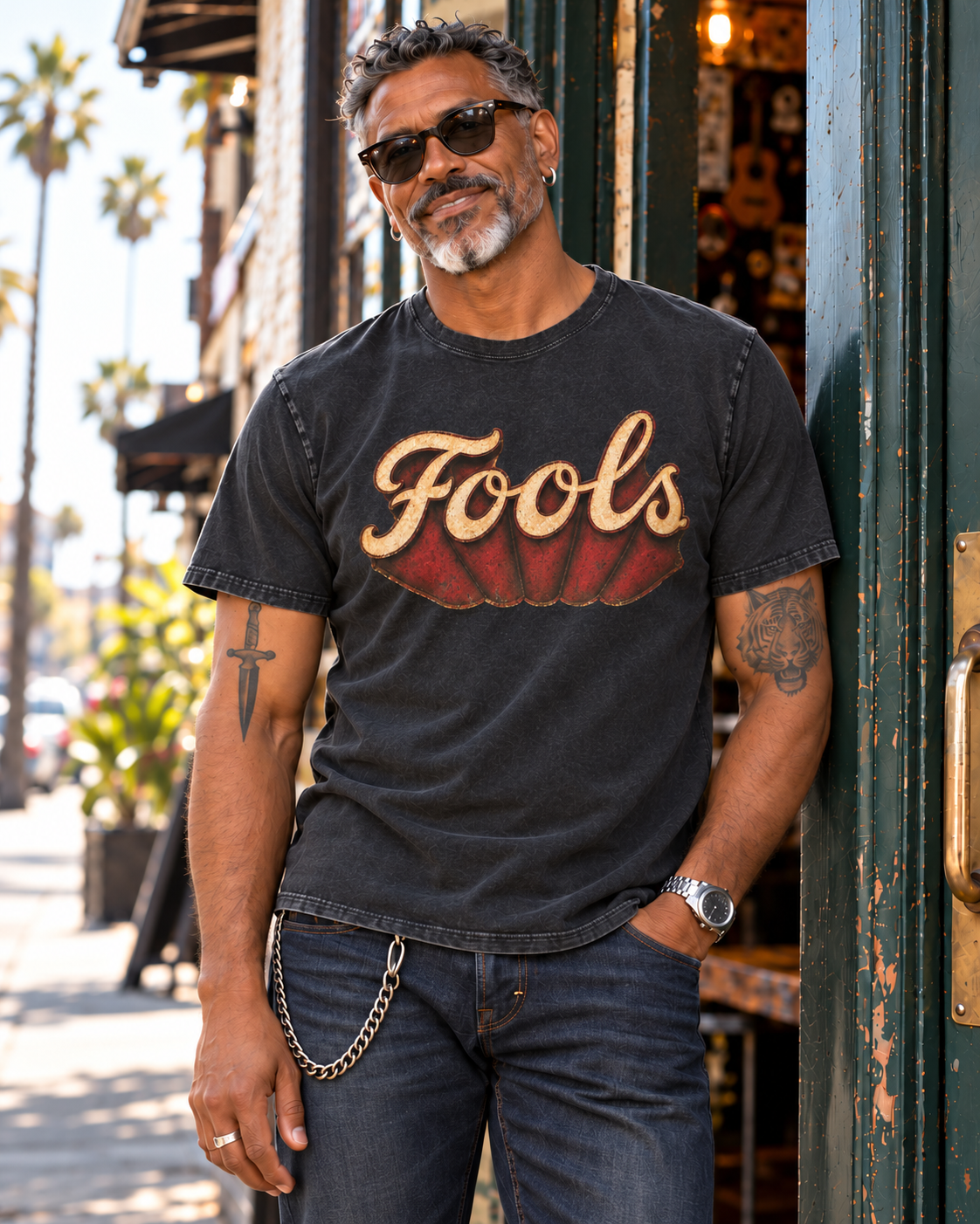 Close-up of the distressed FOOLS Dive Bar Tee with cream and red artwork.
