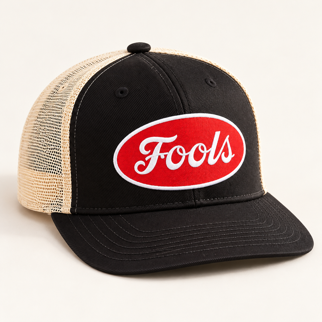Three-quarter product view of black twill and ecru mesh FOOLS Good Times Snap Back with red oval patch.