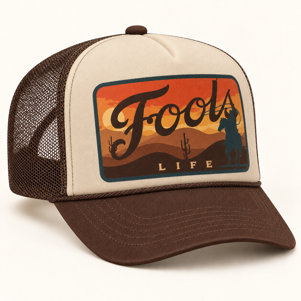 FOOLS Life Lasso beige foam-front and brown mesh trucker hat with flat sunset cowboy artwork and brown curved bill.