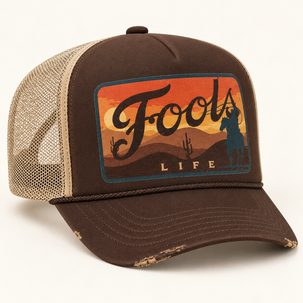 FOOLS Life Lasso brown foam-front and beige mesh trucker hat with flat sunset cowboy artwork and vintage worn bill.