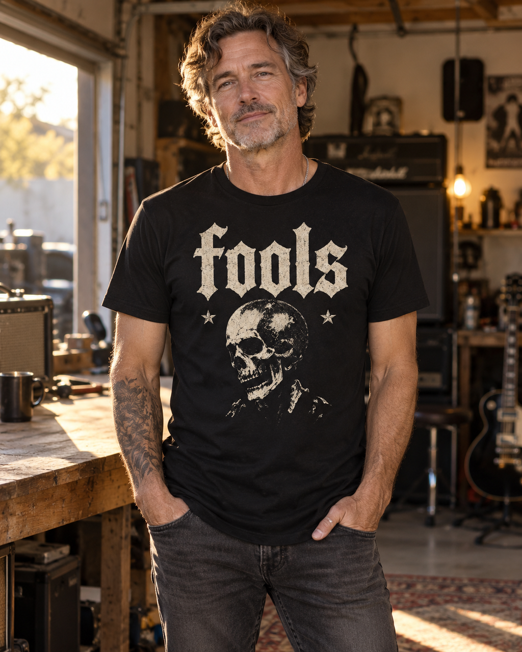 Model concept showing the FOOLS men's black curved-hem tee with distressed bone-colored vintage skull artwork.