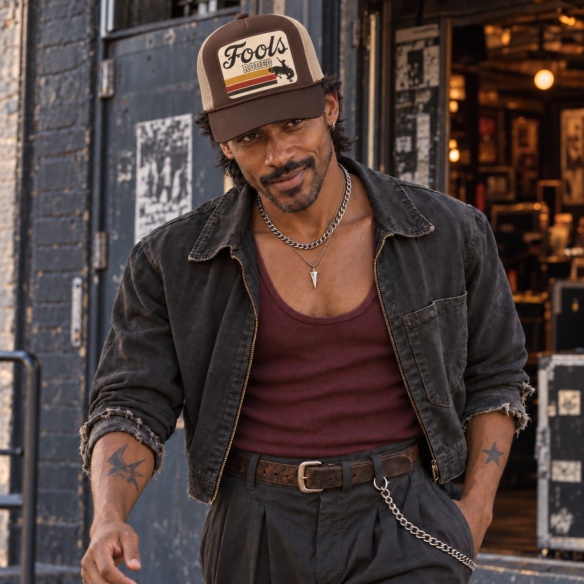 FOOLS Rodeo brown foam-front and beige mesh Otto 39-165 trucker hat styled with a faded black jacket and oxblood tank.