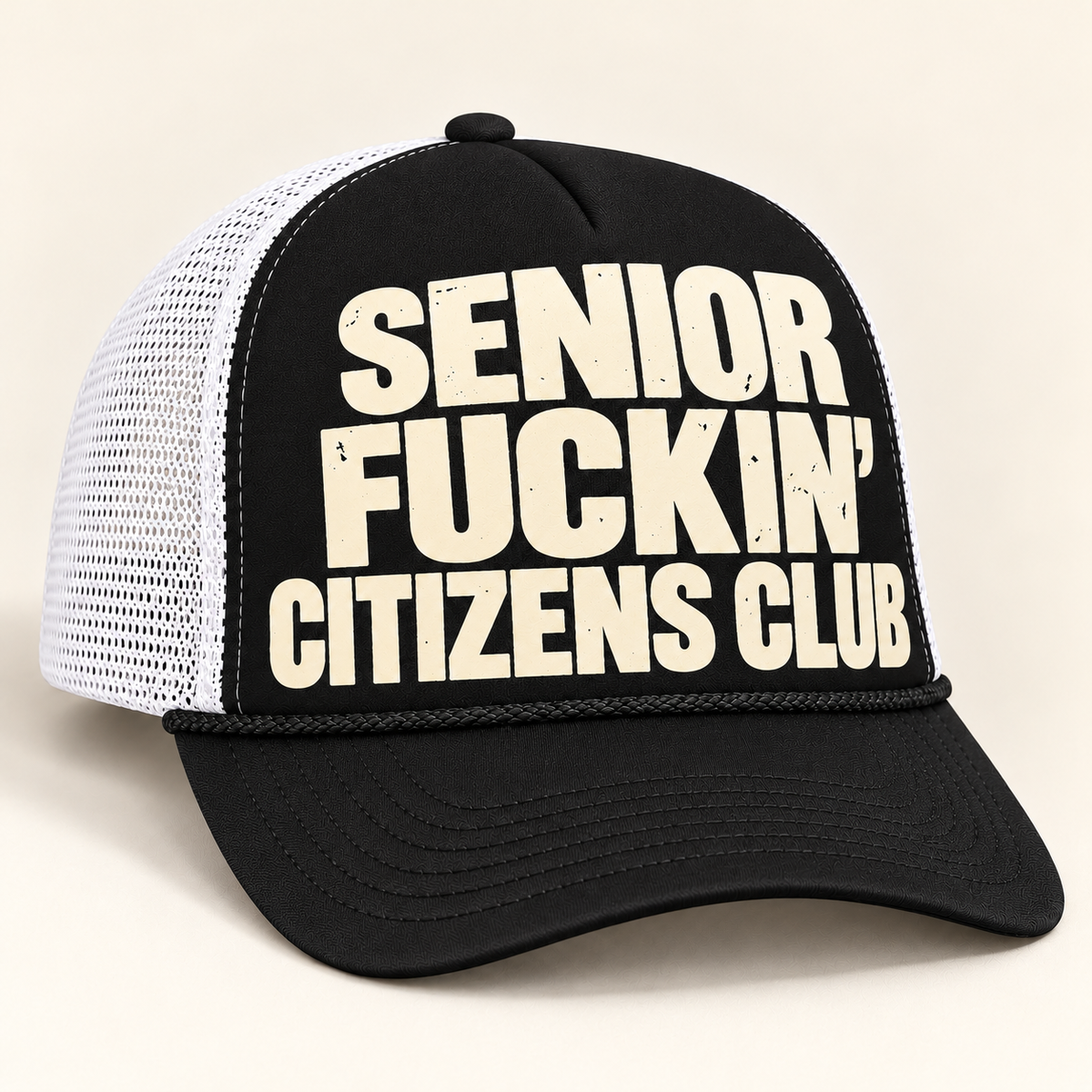 Three-quarter studio view of black-front and white-mesh FOOLS Senior Fuckin’ Citizens Club trucker hat with cream distressed flat print.