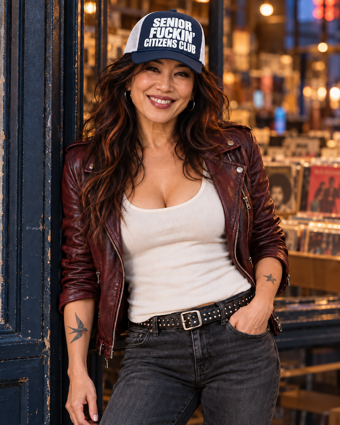 FOOLS navy foam-front and white mesh Senior Fuckin’ Citizens Club trucker hat styled with an oxblood leather jacket and white tank.