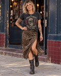 FOOLS Women's Still Here Faded Tee in faded black, styled with a leopard slip skirt, studded belt and black biker boots outside a music venue
